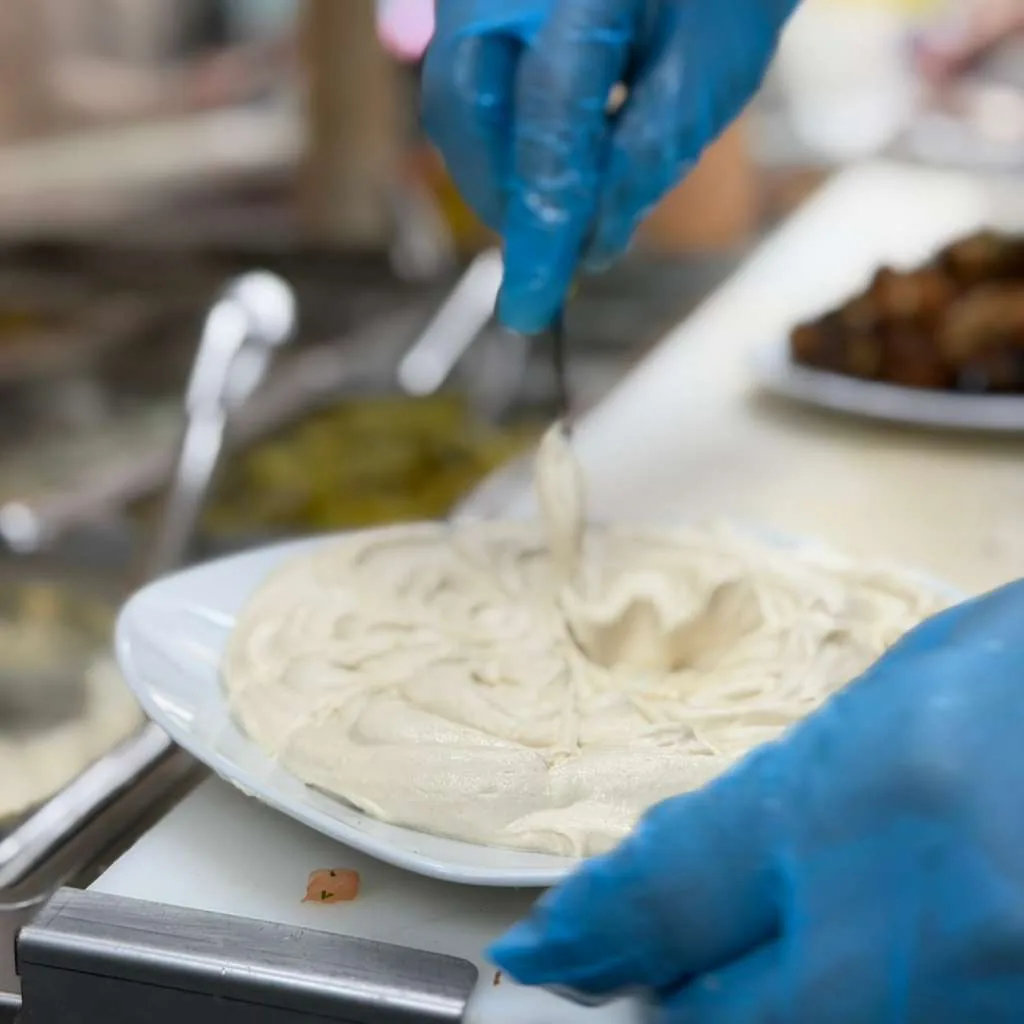 Hummus being plated