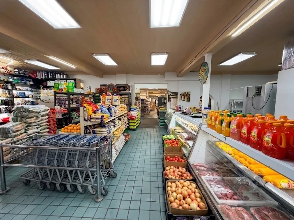 Fresh produce and halal meat counter at Albalad Halal Market in Utica