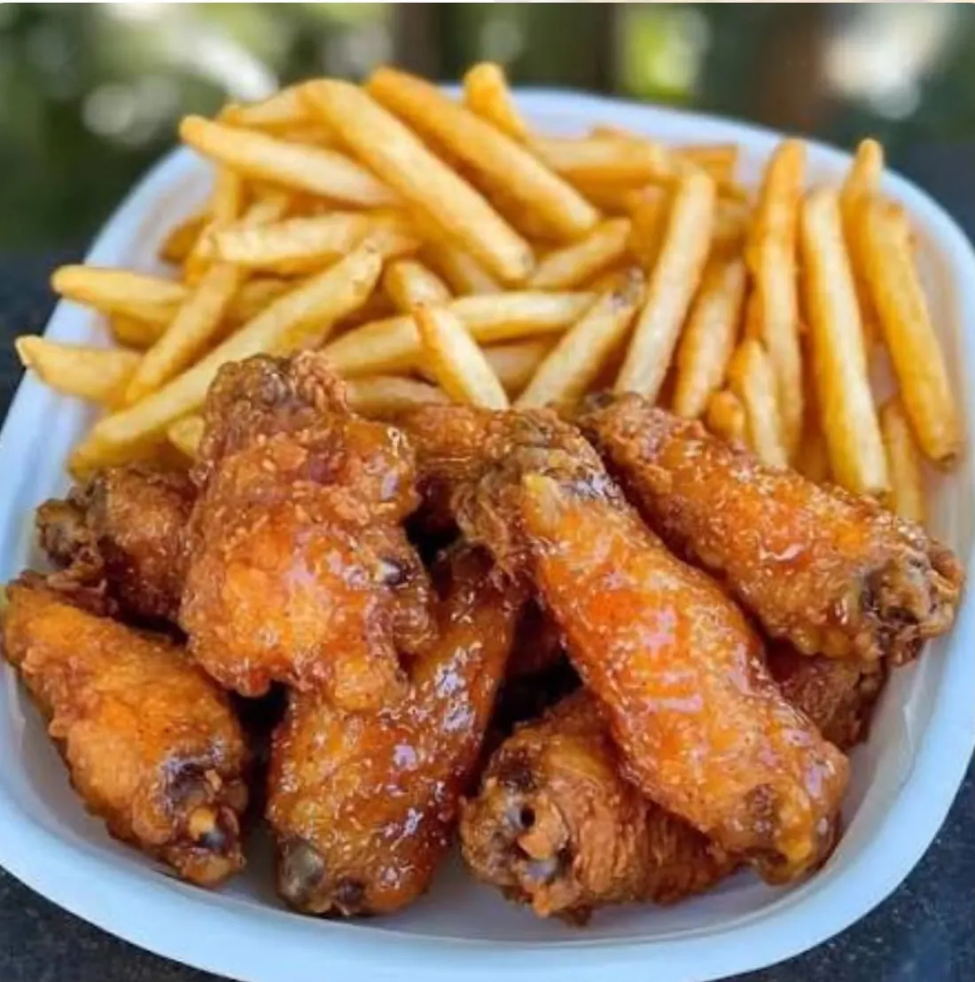 A tray of glazed wings and fries from the truck