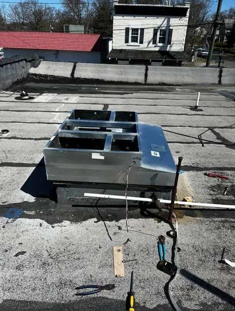 Commercial rooftop HVAC curb installation on flat roof