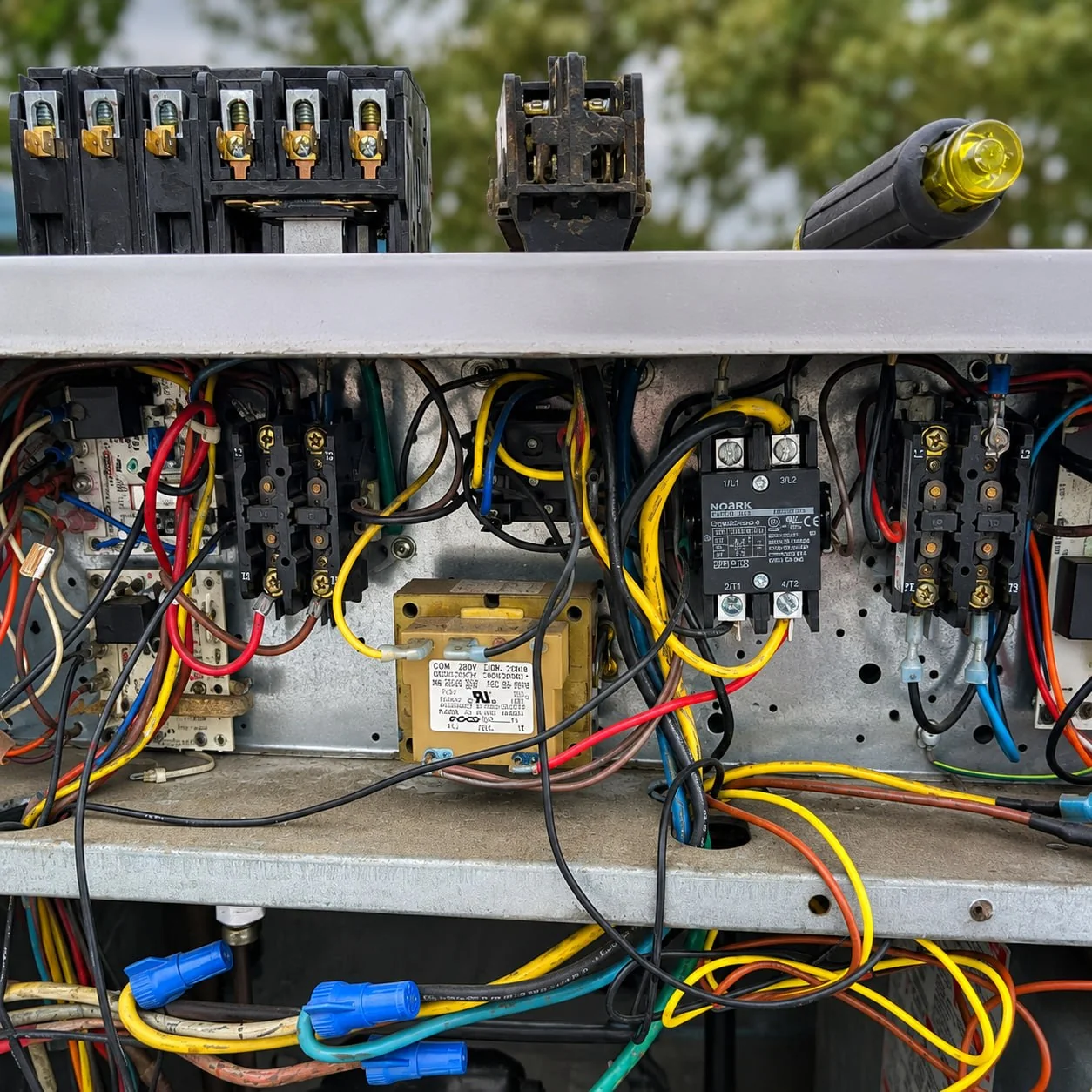 HVAC electrical control panel open during professional repair service