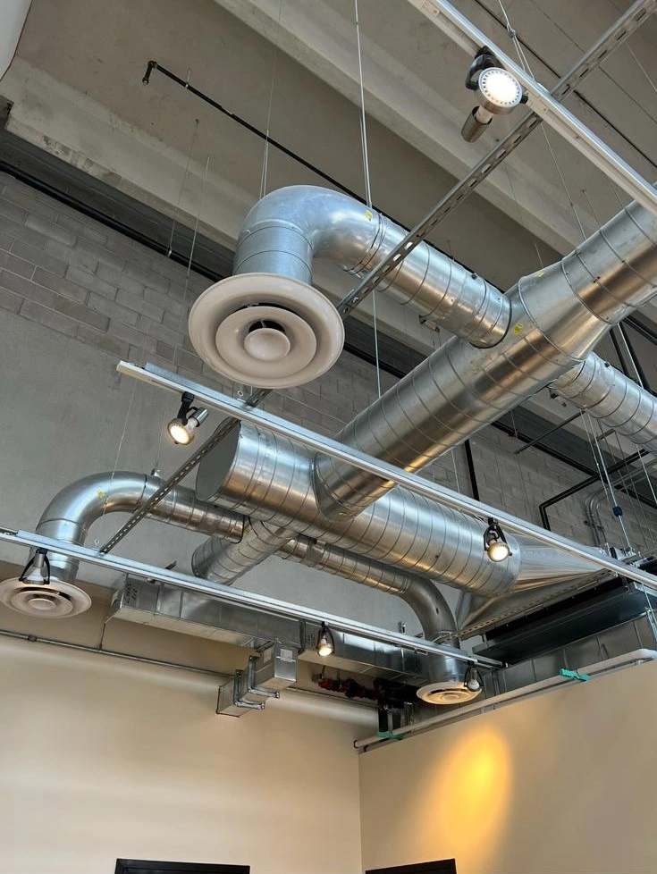 Commercial exposed spiral ductwork and ceiling diffusers