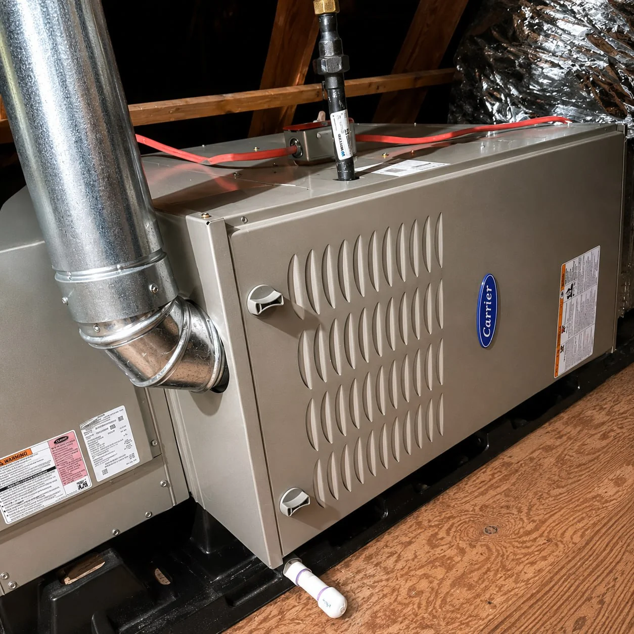 Carrier residential furnace installed in an attic with ductwork