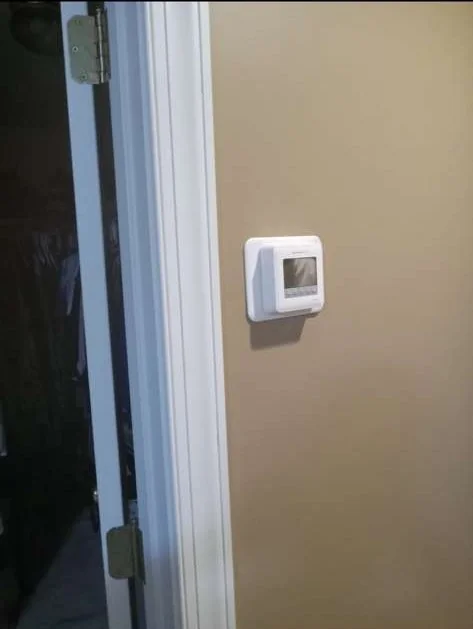 Residential digital thermostat on a wall