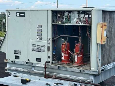 Trane commercial rooftop unit repair on a flat roof